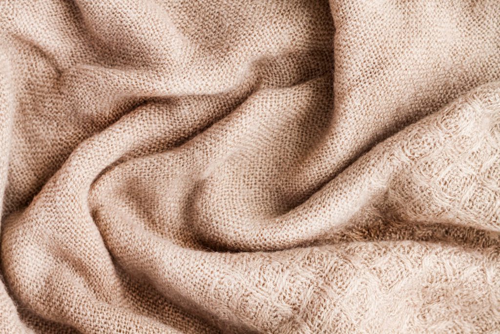 Close-up of soft beige knitted fabric
