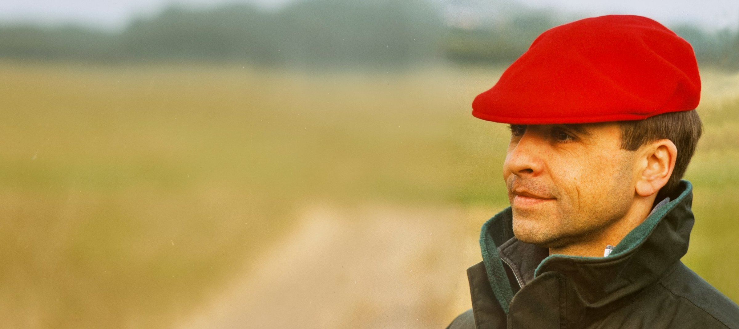 Man in a red cap standing in a field
